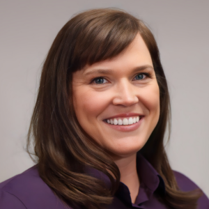 A woman with long brown hair wearing purple shirt.