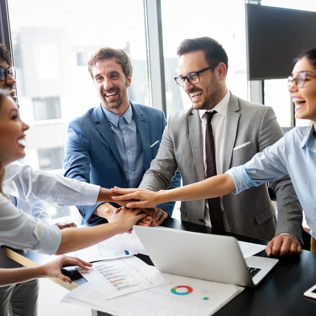 A group of people in suits and ties shaking hands.